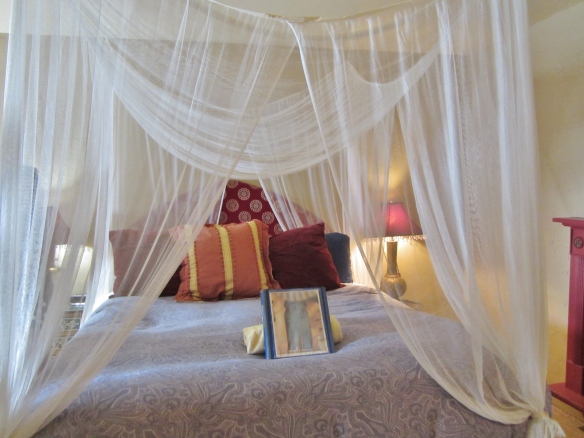 Canopied Cal-King beds are featured in each room.